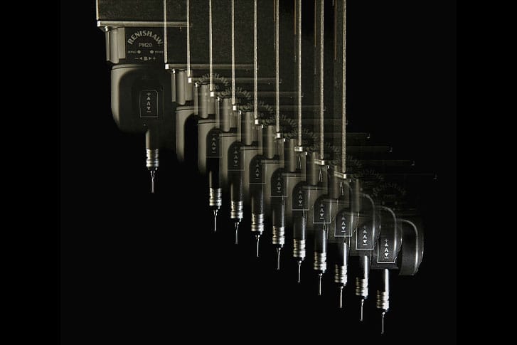 Series of overlapping images showing the motion of a precision tool or probe with a needle-like tip, set against a black background to emphasize high-tech, industrial design and movement.